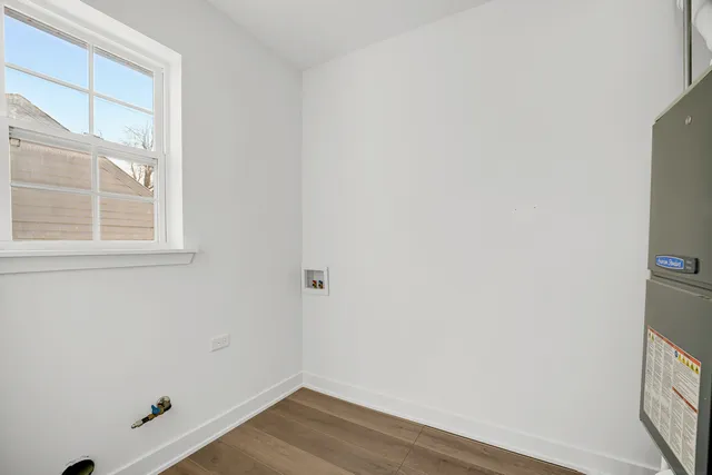 a view of a small space with wooden floor and a window