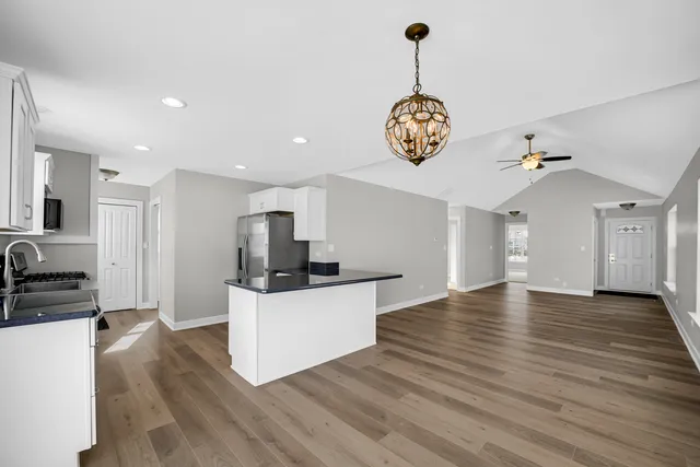 a view of kitchen with sink microwave refrigerator and stove