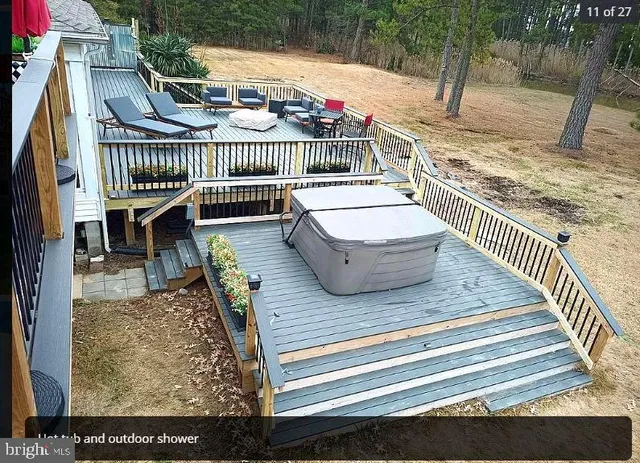a view of balcony with wooden floor and outdoor seating