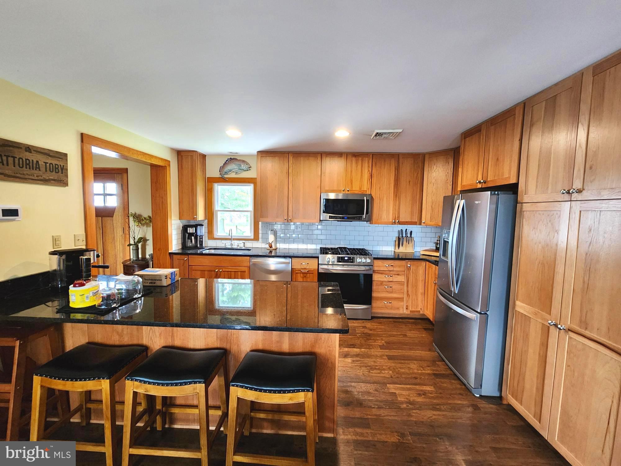 3310 Belfiore Road Church Creek, MD 21622 - Photo 17 of 55 a kitchen with granite countertop wooden cabinets and stainless steel appliances