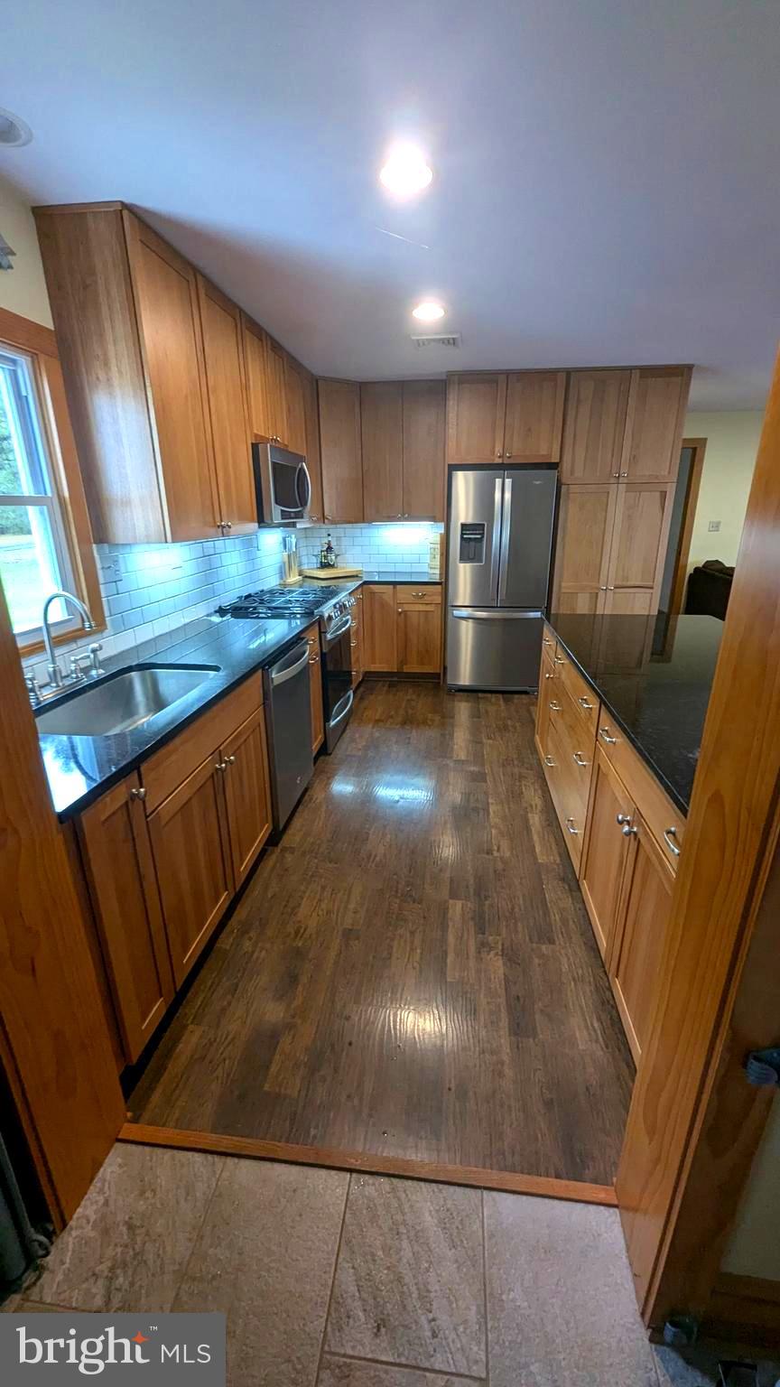 3310 Belfiore Road Church Creek, MD 21622 - Photo 21 of 55 a kitchen with stainless steel appliances wooden cabinets a stove and a refrigerator