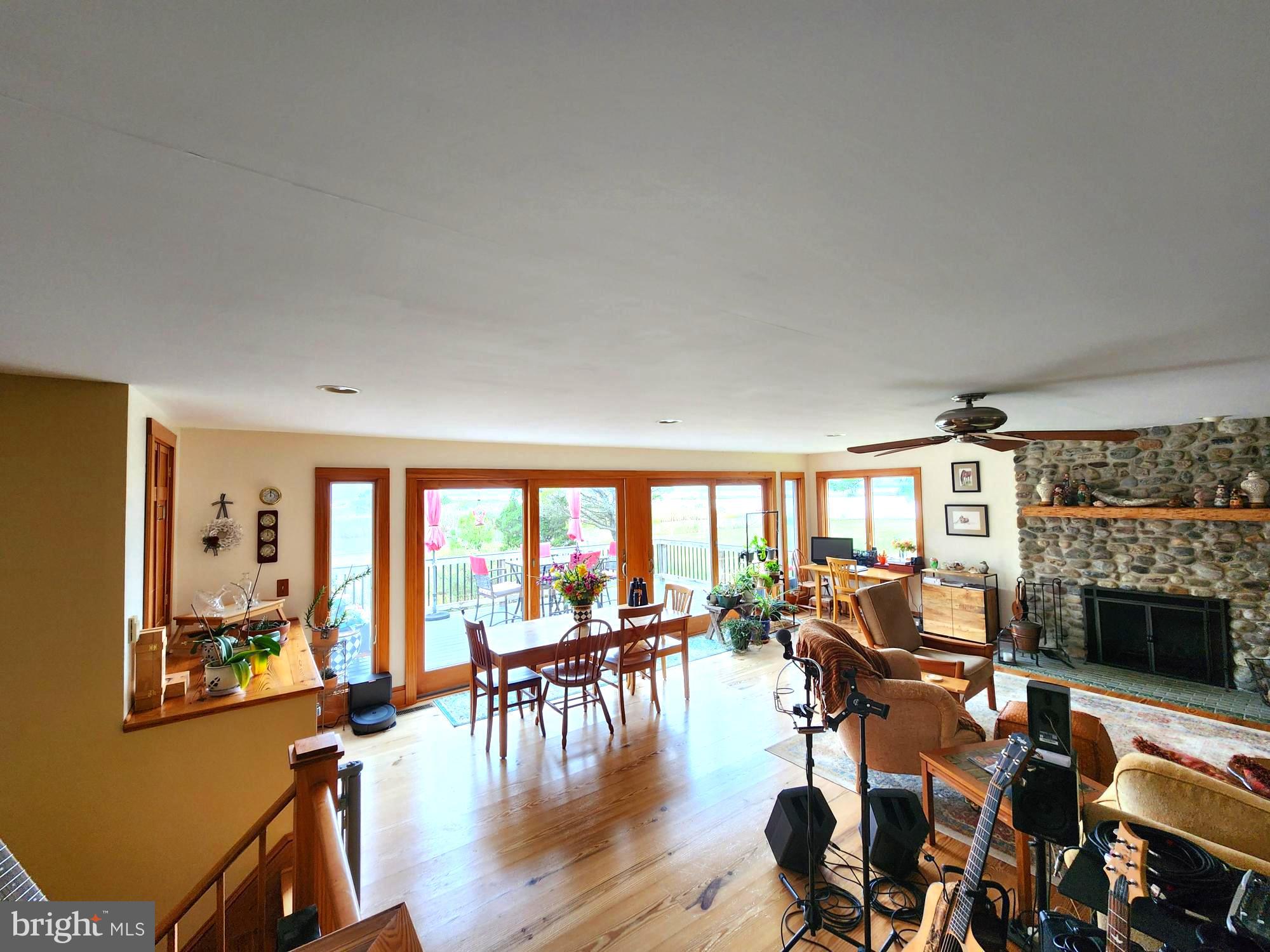 3310 Belfiore Road Church Creek, MD 21622 - Photo 28 of 55 a living room with furniture a fireplace and large windows