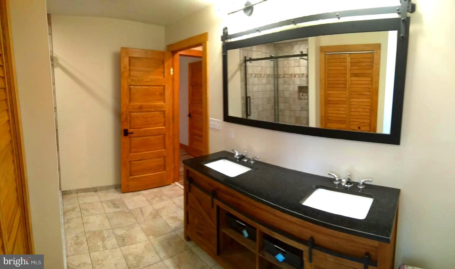 3310 Belfiore Road Church Creek, MD 21622 - Photo 35 of 55 a bathroom with a sink a mirror and a shower