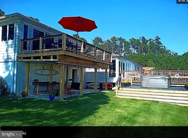 a view of a house with a yard porch and sitting area
