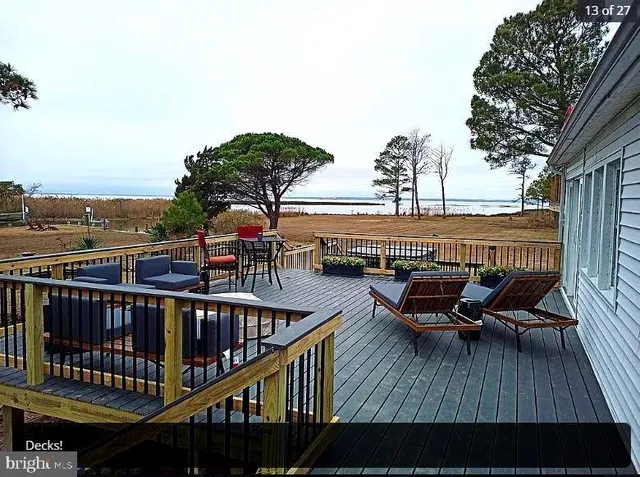 a view of a patio with a table chairs and a wooden deck