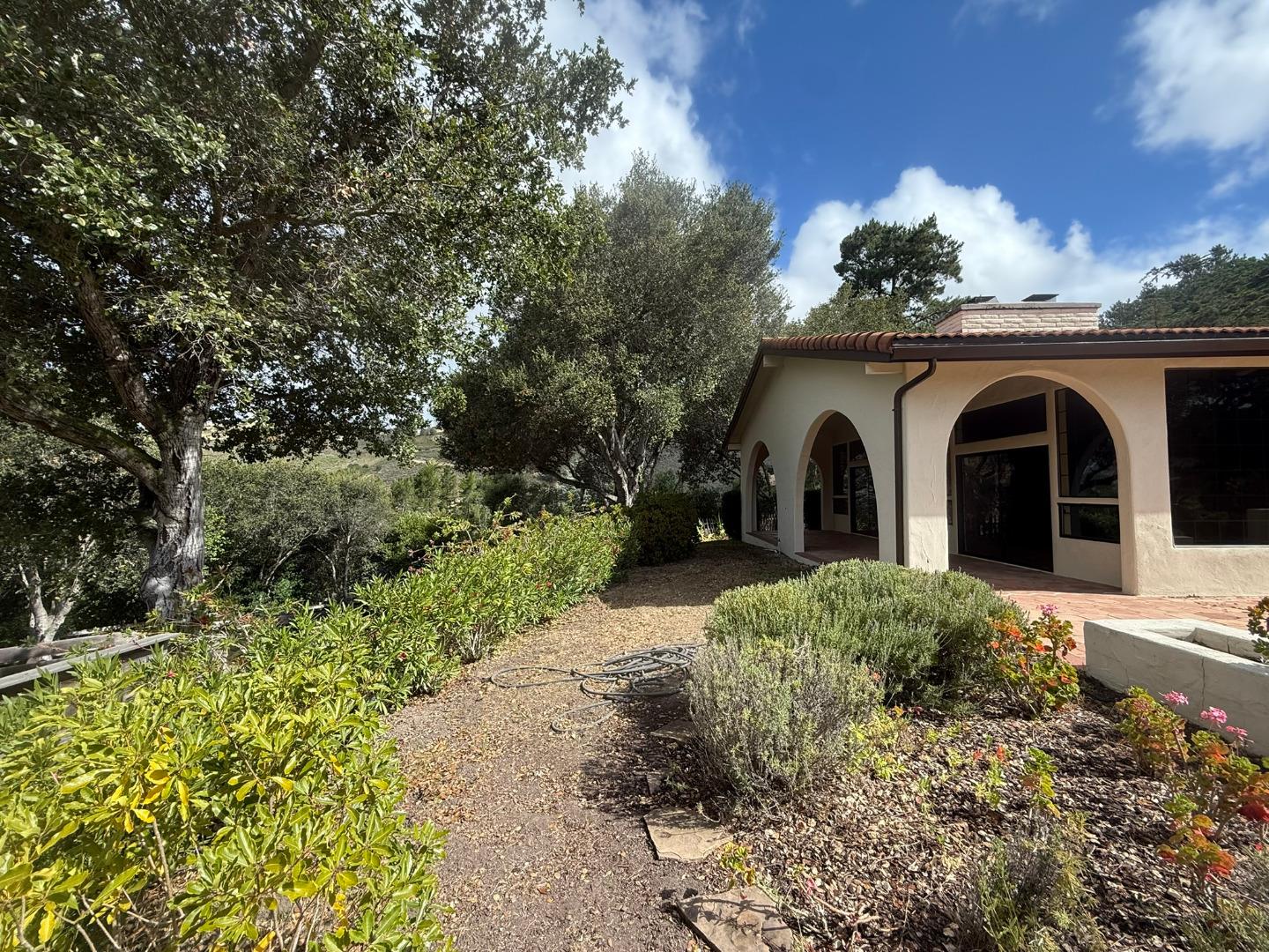 11585 McCarthy Road Carmel Valley, CA 93924 - Photo 10 of 52 a view of a house with a yard and pathway