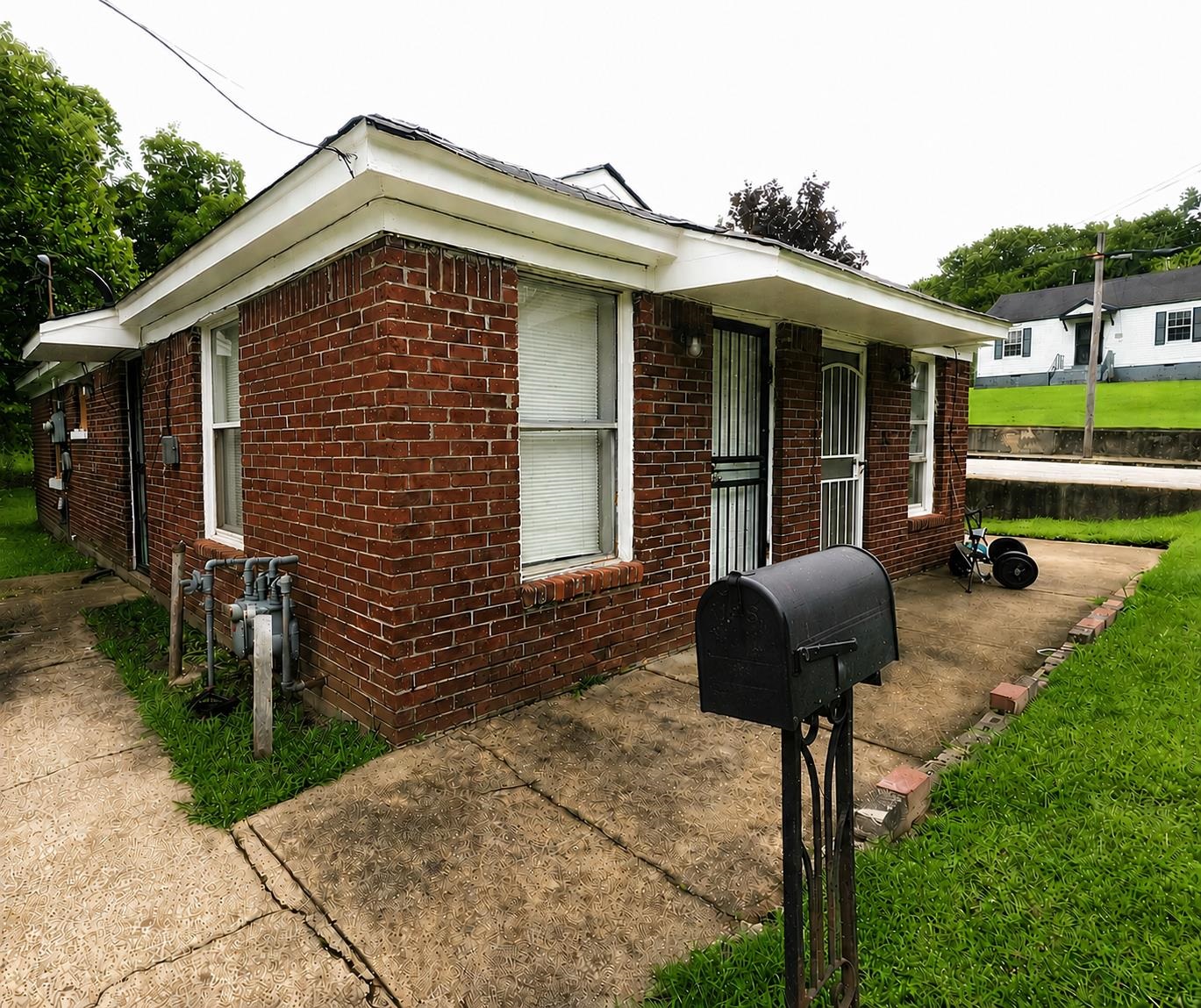 1672 Clancy Street Memphis, TN 38106 - Photo 1 of 7 Red brick exterior with white trim and a covered entry