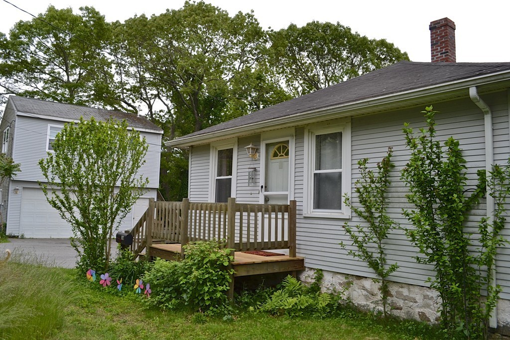 16 Harvard Street Fairhaven, MA 02719 - Photo 1 of 14 a front view of a house with garden