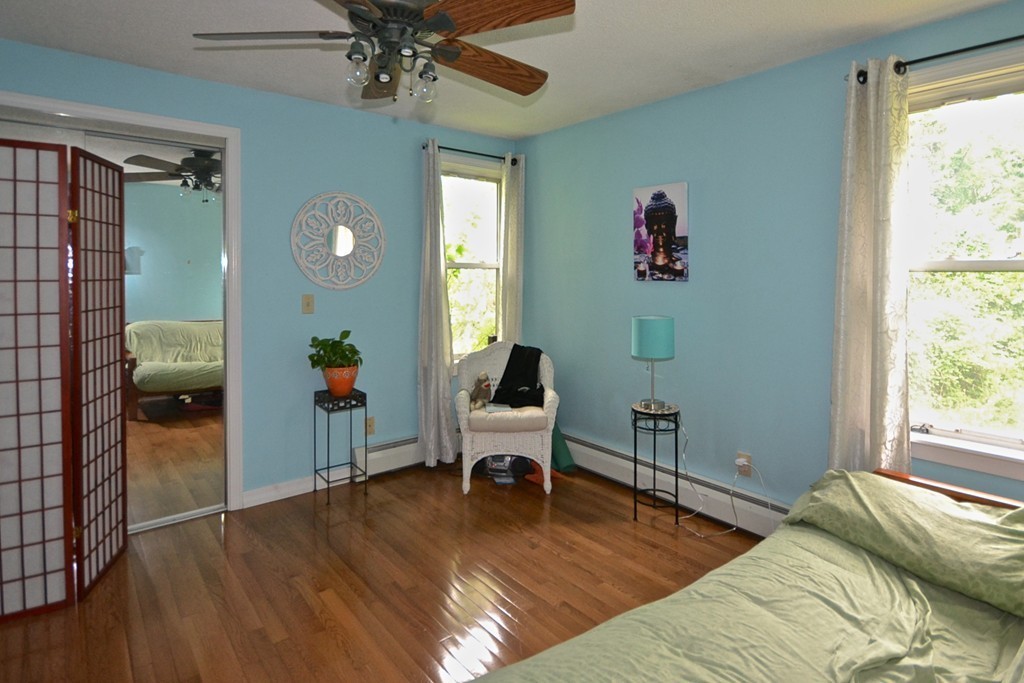 16 Harvard Street Fairhaven, MA 02719 - Photo 11 of 14 a bedroom with a bed and a chandelier
