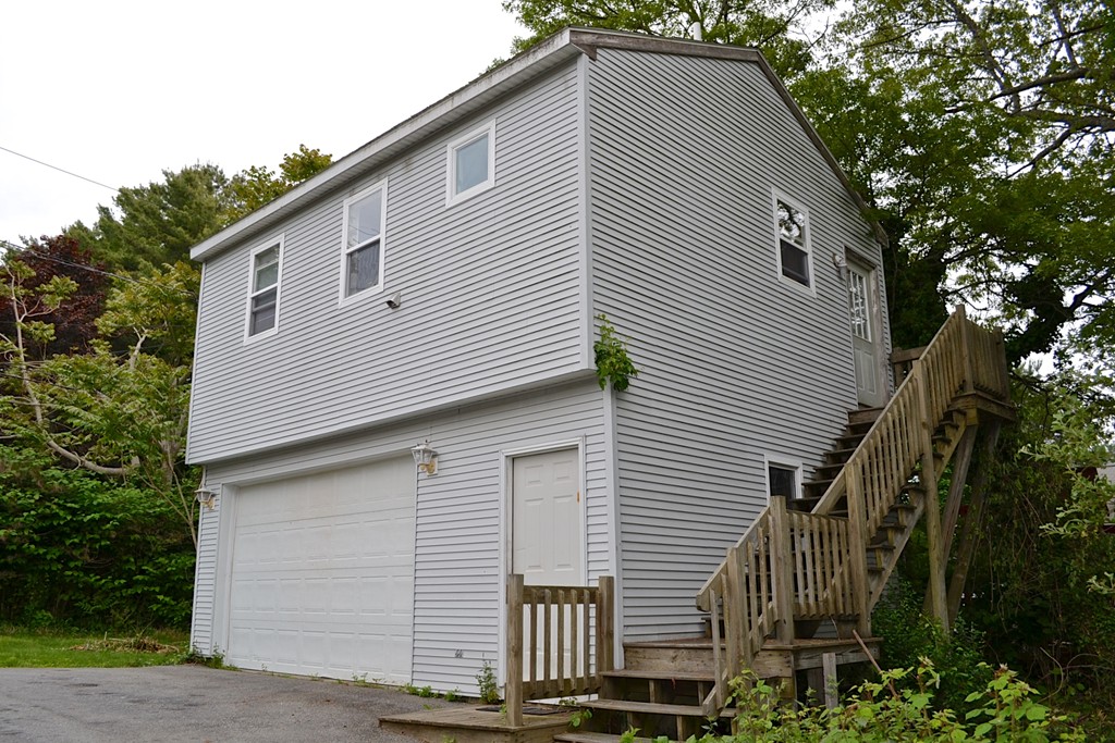 16 Harvard Street Fairhaven, MA 02719 - Photo 4 of 14 a front view of a house with a garage