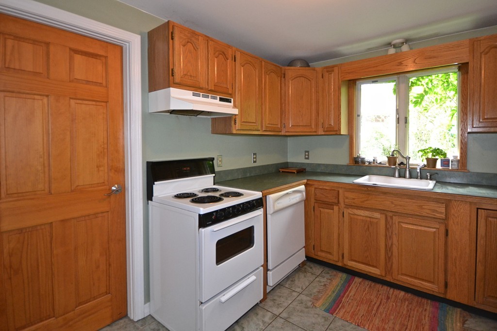 16 Harvard Street Fairhaven, MA 02719 - Photo 6 of 14 a kitchen with a stove a sink and a cabinets