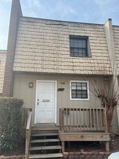 a front view of a house with stairs