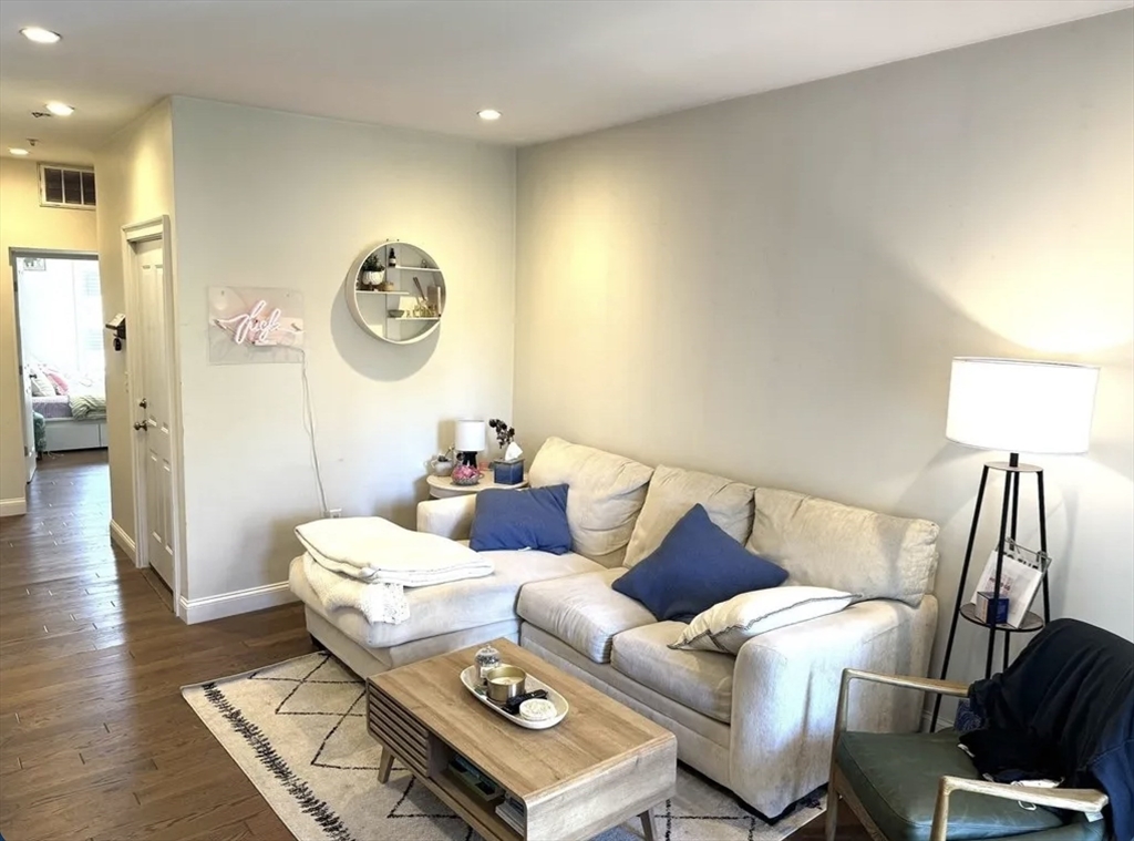 7 Loring Street, Unit 2 Boston, MA 02127 - Photo 1 of 10 a living room with furniture and a lamp