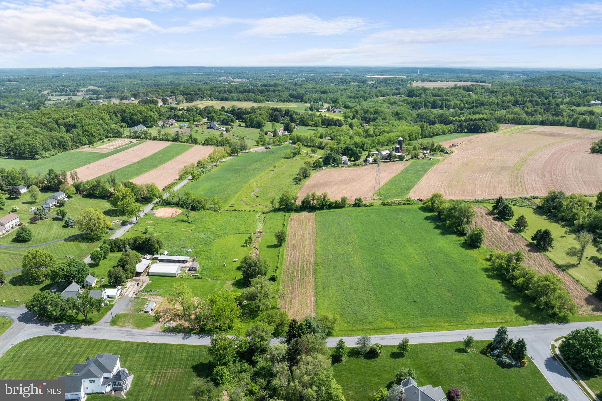 an aerial view of residential houses with outdoor space and river