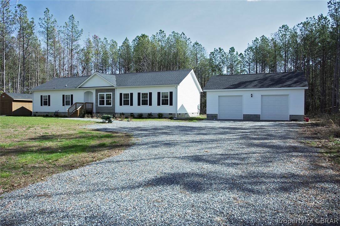1496 Elsom Mascot Road Mattaponi, VA 23110 - Photo 2 of 33 a front view of a house with a garden and trees