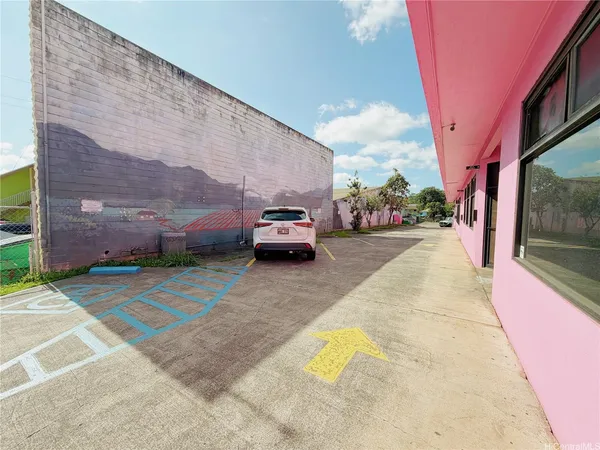 a view of a cars park in front of a building