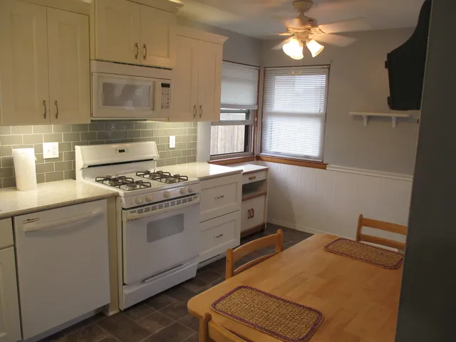 a kitchen with cabinets appliances and a window
