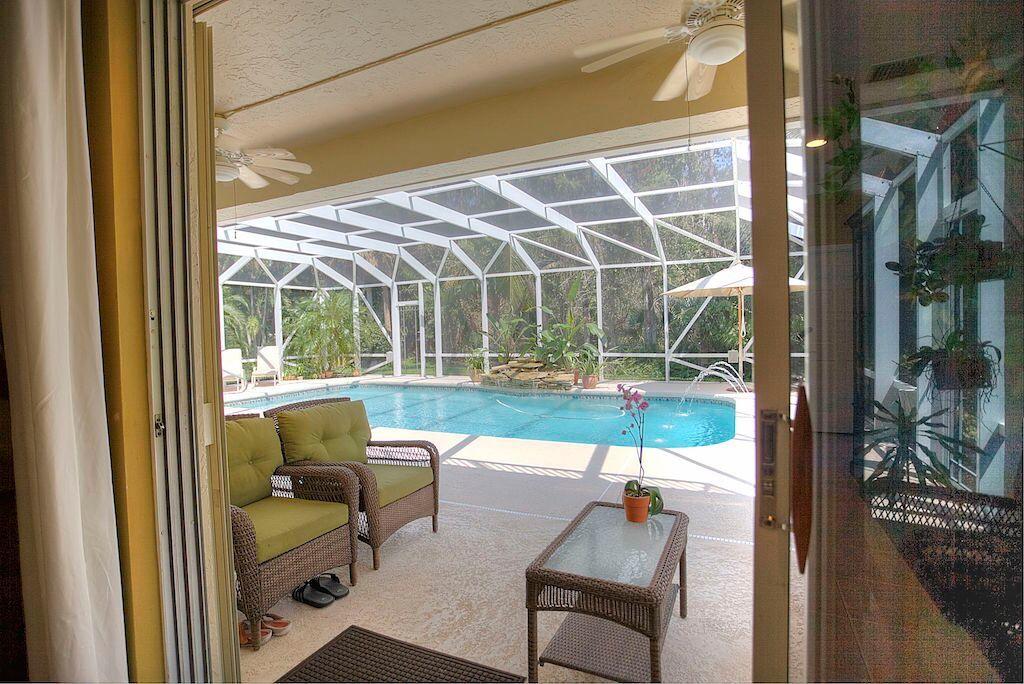 774 Cedar Cove Road Wellington, FL 33414 - Photo 10 of 22 Family Room looking onto patio/pool