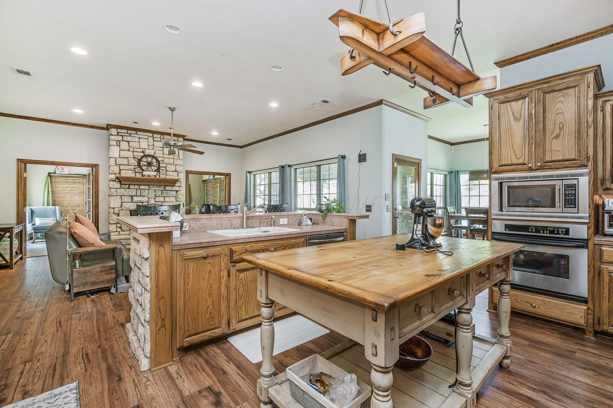 7 Pebble Beach Court Amarillo, TX 79124 - Photo 15 of 67 a kitchen with stainless steel appliances granite countertop a stove and a refrigerator