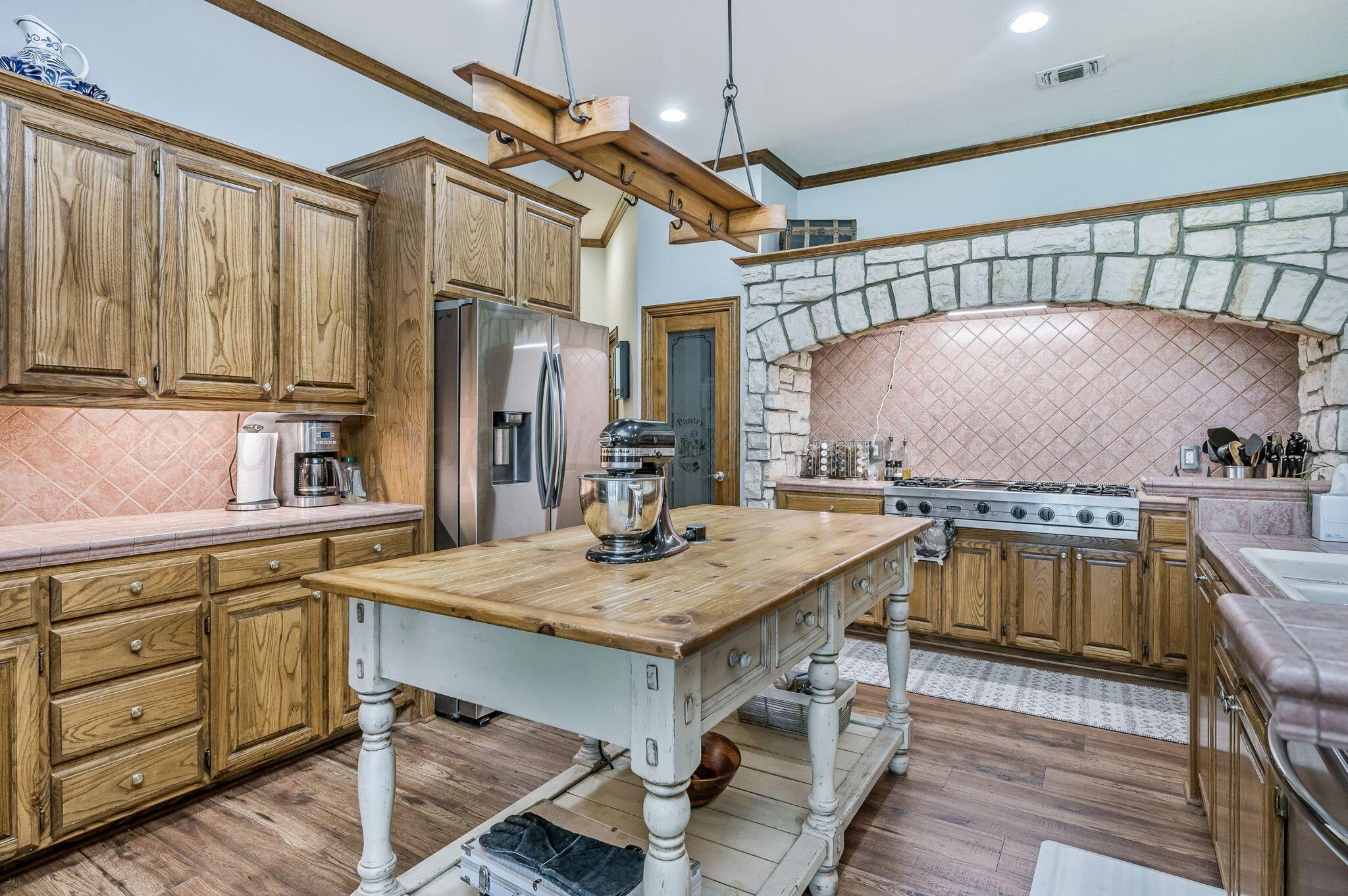 7 Pebble Beach Court Amarillo, TX 79124 - Photo 5 of 67 a kitchen with a table chairs sink and cabinets