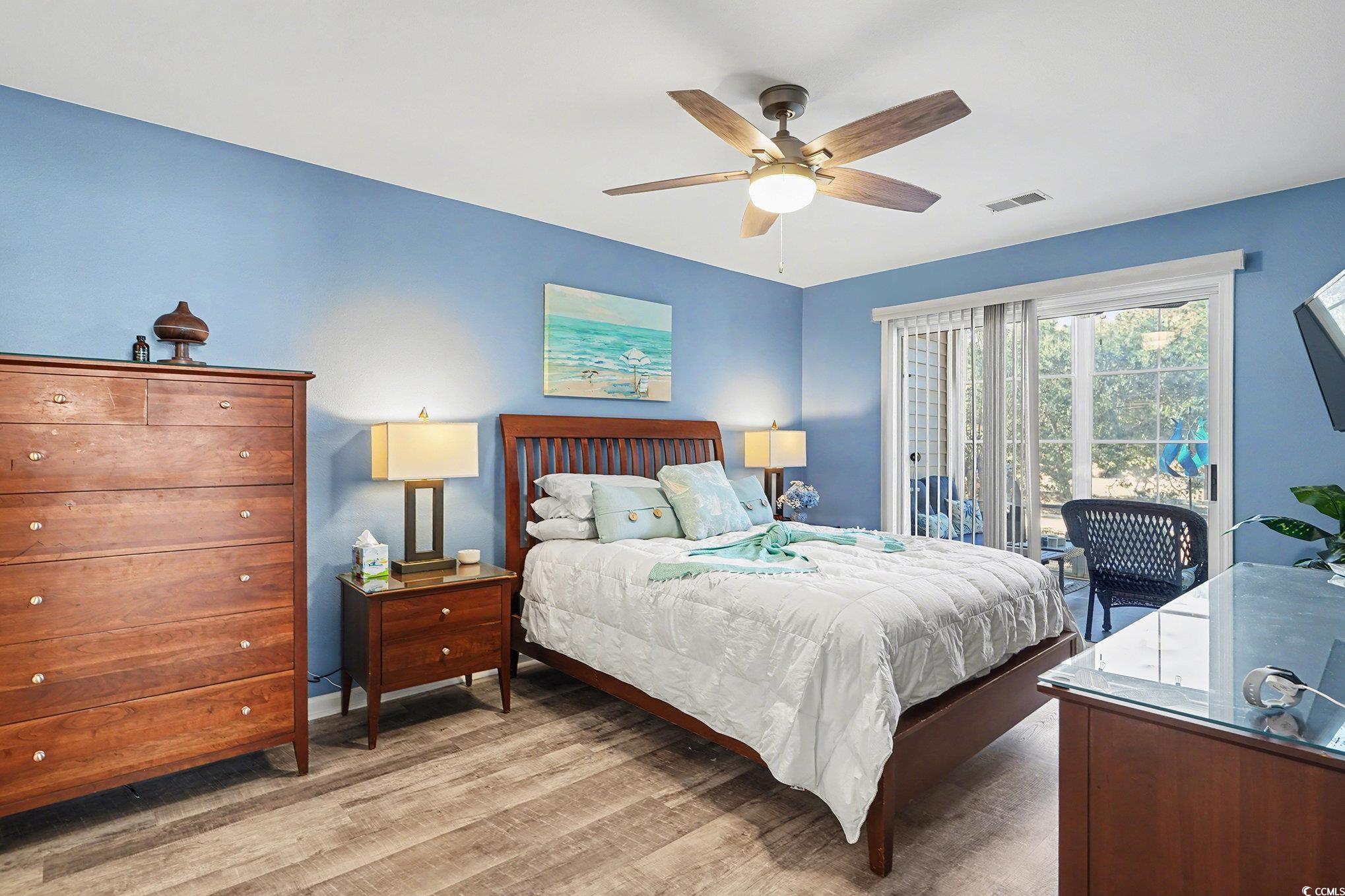 725 Blue Stem Drive, Unit 66B Pawleys Island, SC 29585 - Photo 13 of 30 Bedroom with wood finished floors, ceiling fan, and access to outside