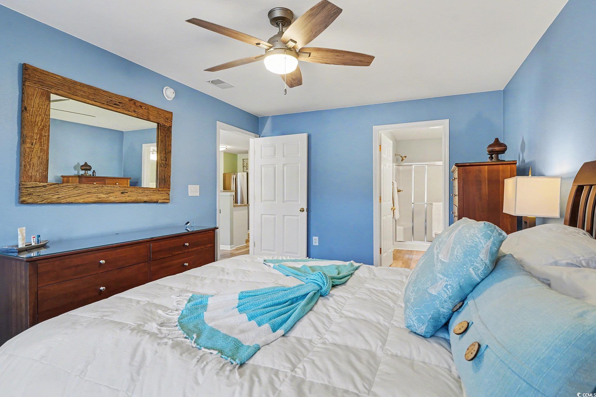 725 Blue Stem Drive, Unit 66B Pawleys Island, SC 29585 - Photo 15 of 30 Bedroom featuring connected bathroom and ceiling fan