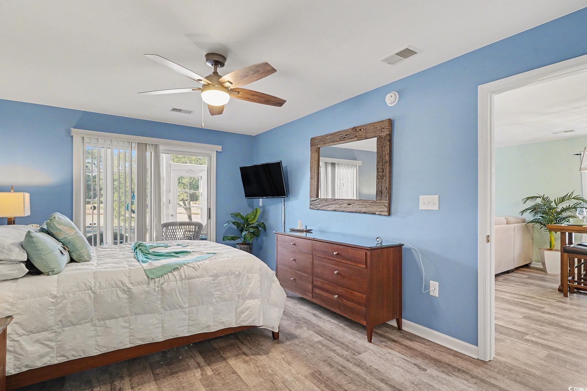 725 Blue Stem Drive, Unit 66B Pawleys Island, SC 29585 - Photo 16 of 30 Bedroom featuring light wood-style flooring, access to outside, and a ceiling fan