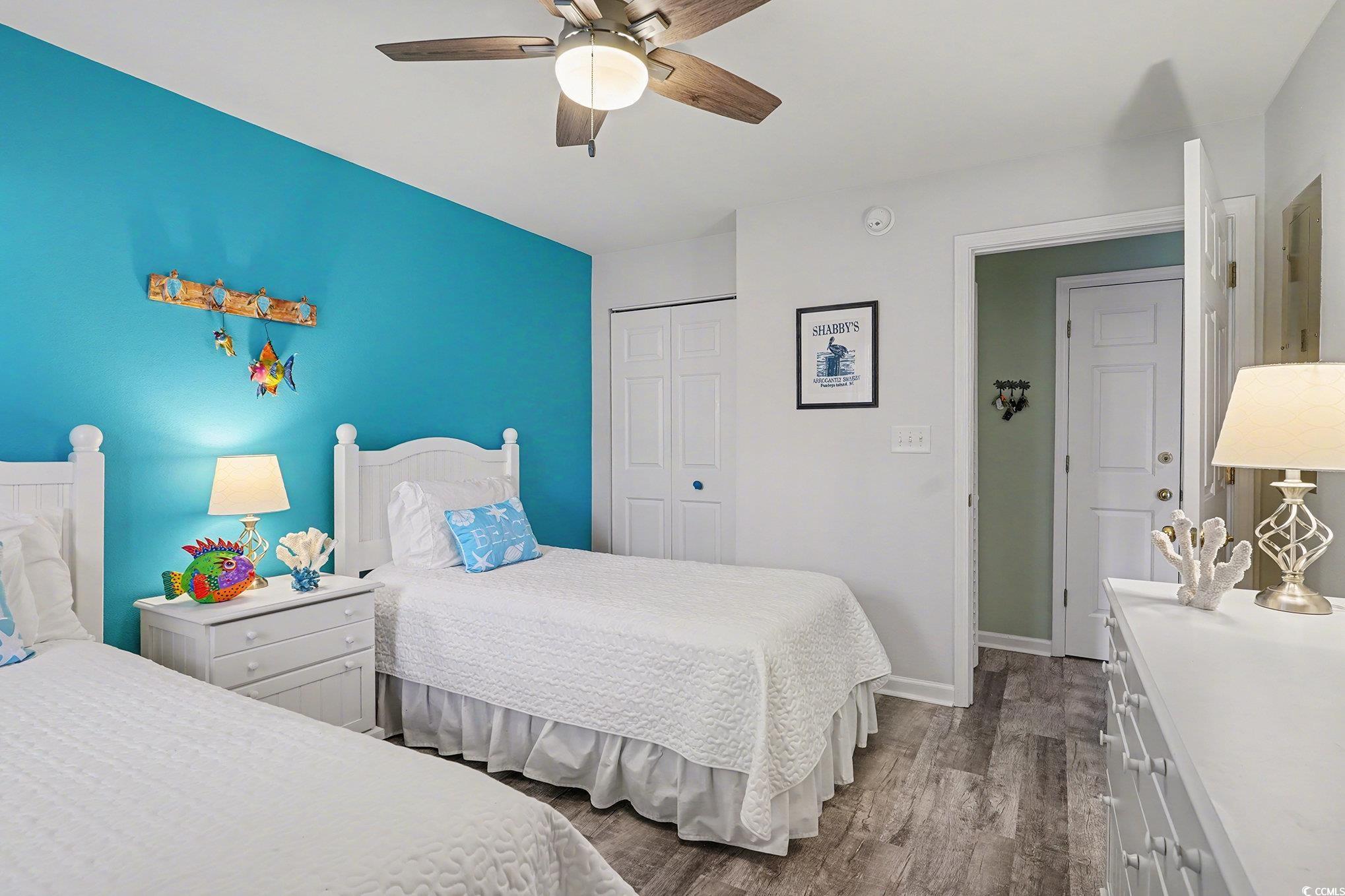 725 Blue Stem Drive, Unit 66B Pawleys Island, SC 29585 - Photo 19 of 30 Bedroom featuring a closet, dark wood-type flooring, and ceiling fan