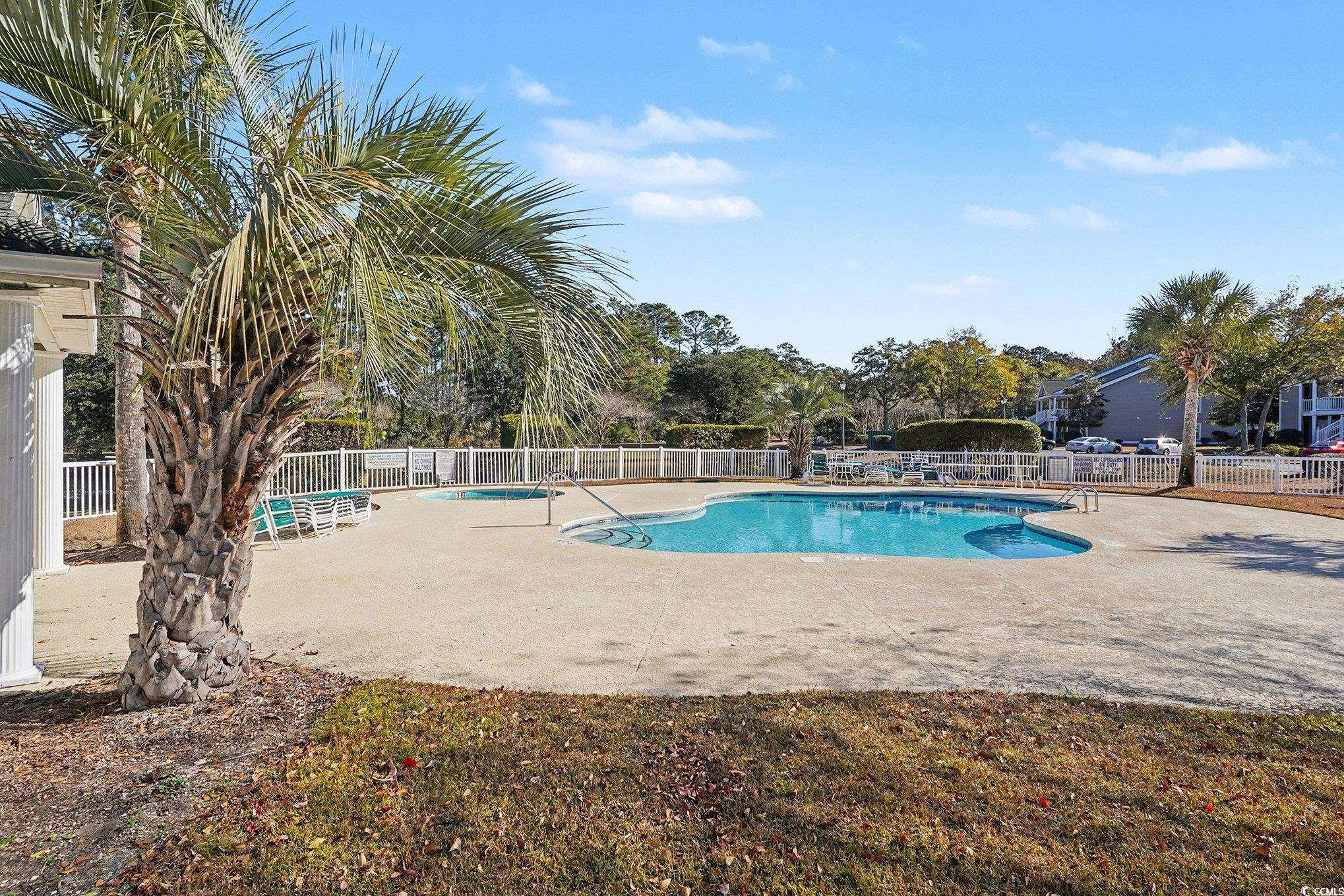 725 Blue Stem Drive, Unit 66B Pawleys Island, SC 29585 - Photo 28 of 30 Community pool with a patio