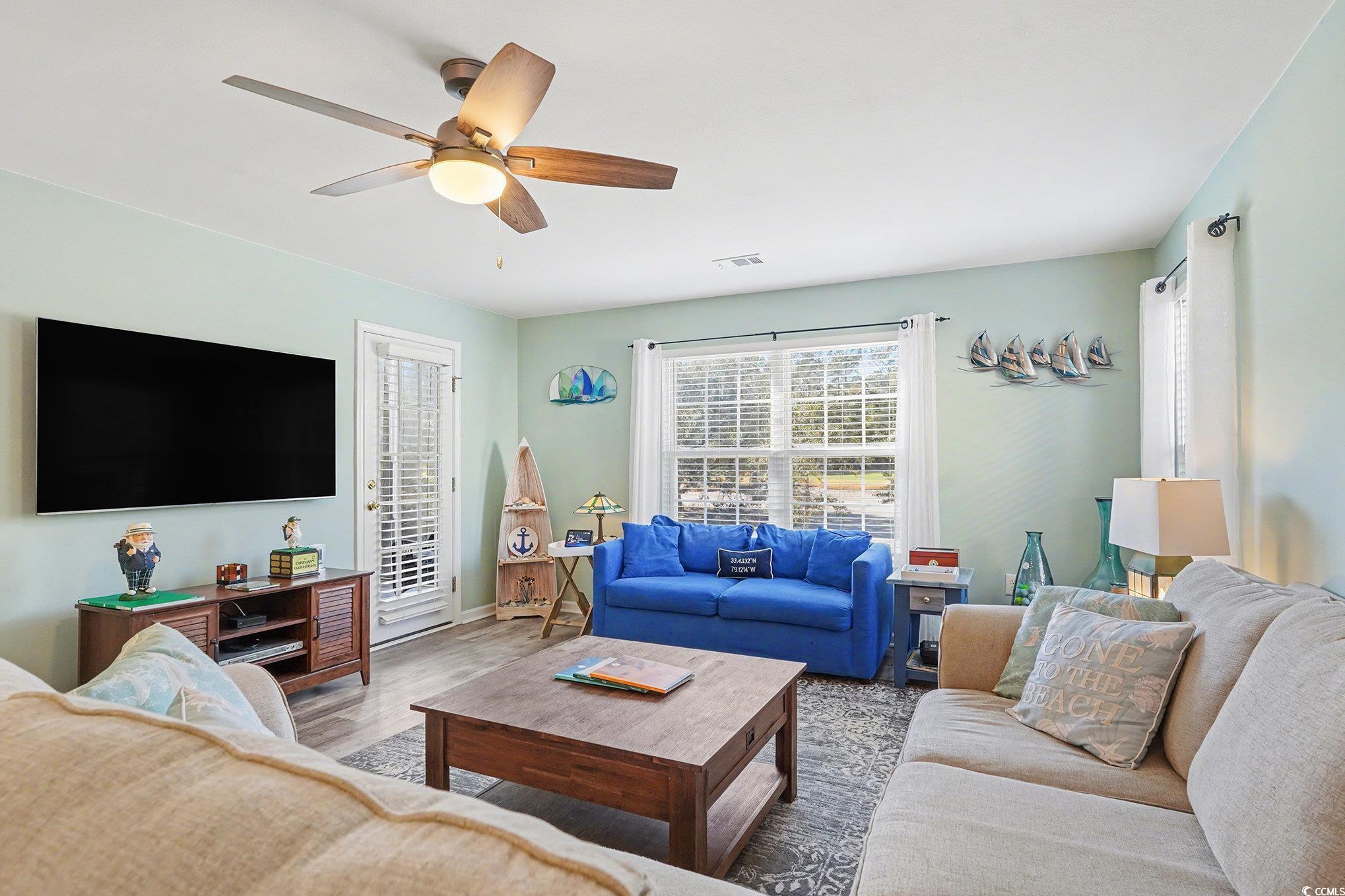 725 Blue Stem Drive, Unit 66B Pawleys Island, SC 29585 - Photo 7 of 30 Living area featuring wood finished floors and ceiling fan