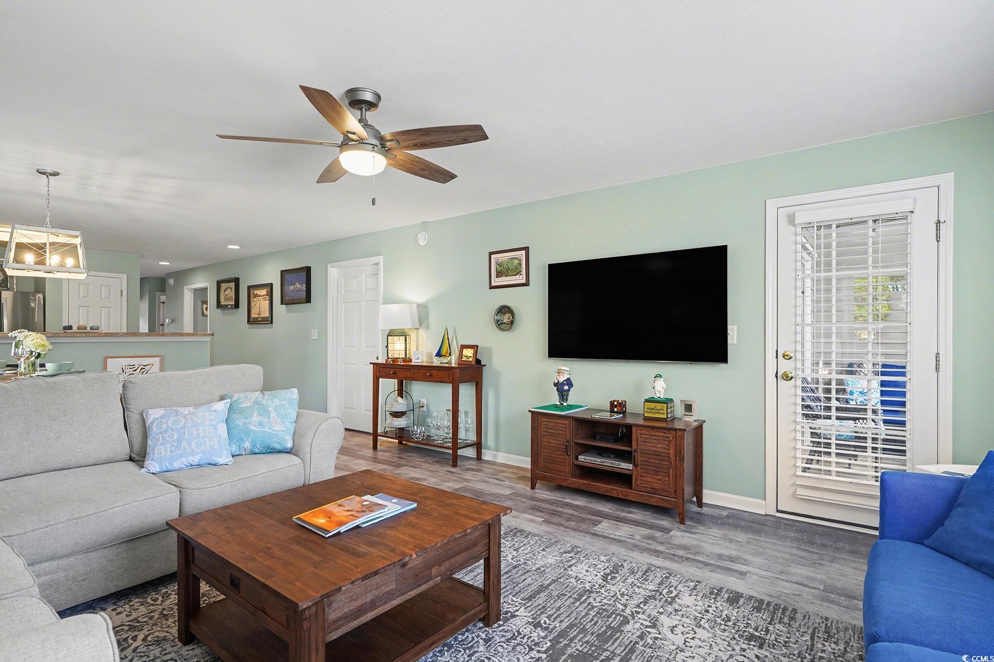 725 Blue Stem Drive, Unit 66B Pawleys Island, SC 29585 - Photo 9 of 30 Living room with wood finished floors, ceiling fan, and a chandelier