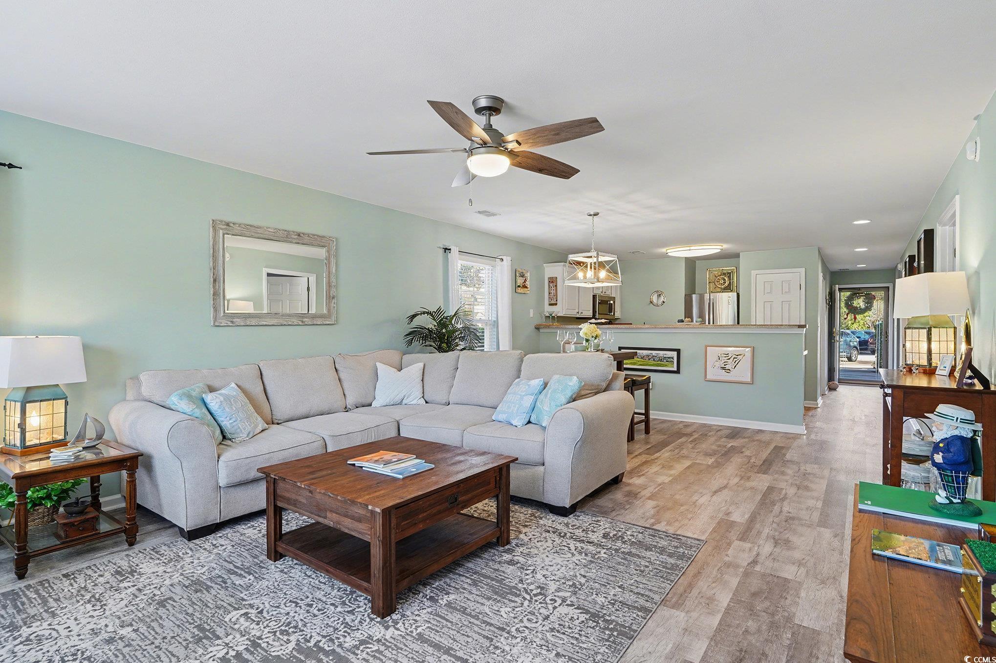725 Blue Stem Drive, Unit 66B Pawleys Island, SC 29585 - Photo 10 of 30 Living room with wood finished floors and ceiling fan
