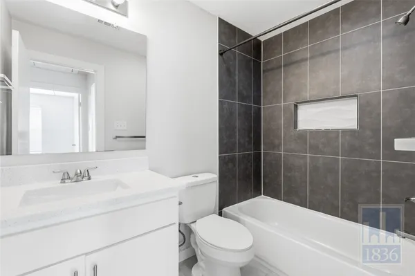 a bathroom with a sink mirror and toilet
