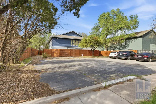a view of large house with a road and trees