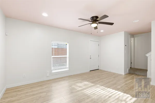 a view of an empty room and a window