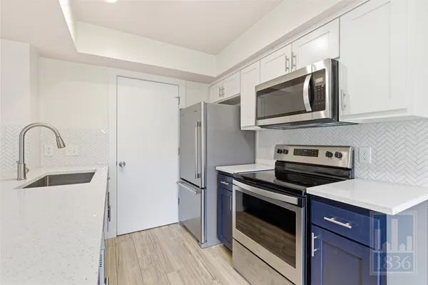 a kitchen with stainless steel appliances granite countertop a stove microwave and refrigerator
