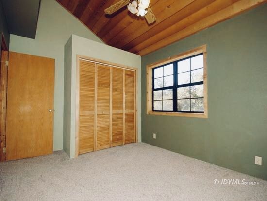 26720 Saunders Meadow Road Idyllwild, CA 92549 - Photo 54 of 65 an empty room with windows closet and chandelier fan