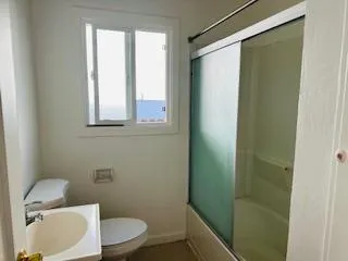a front view of a house with yard tree and wooden fence