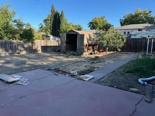 a kitchen with granite countertop a stove a sink and a microwave