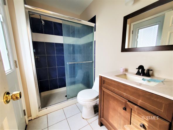 548 South Fairview Street Ridgecrest, CA 93555 - Photo 16 of 35 a bathroom with a sink a toilet a shower and a mirror