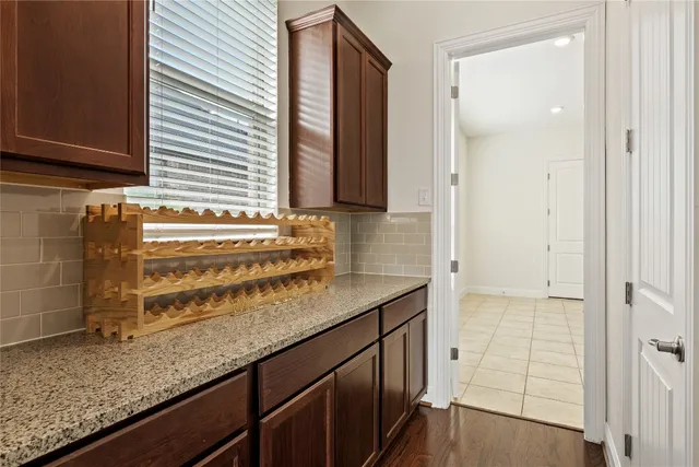 view of kitchen with granite countertop window sink and cabinets