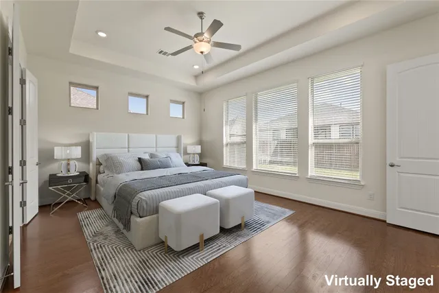 a spacious bedroom with a bed couch and a window
