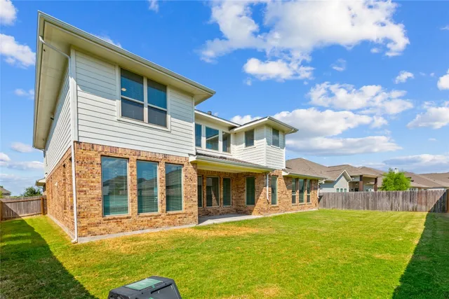 a view of a house with a backyard