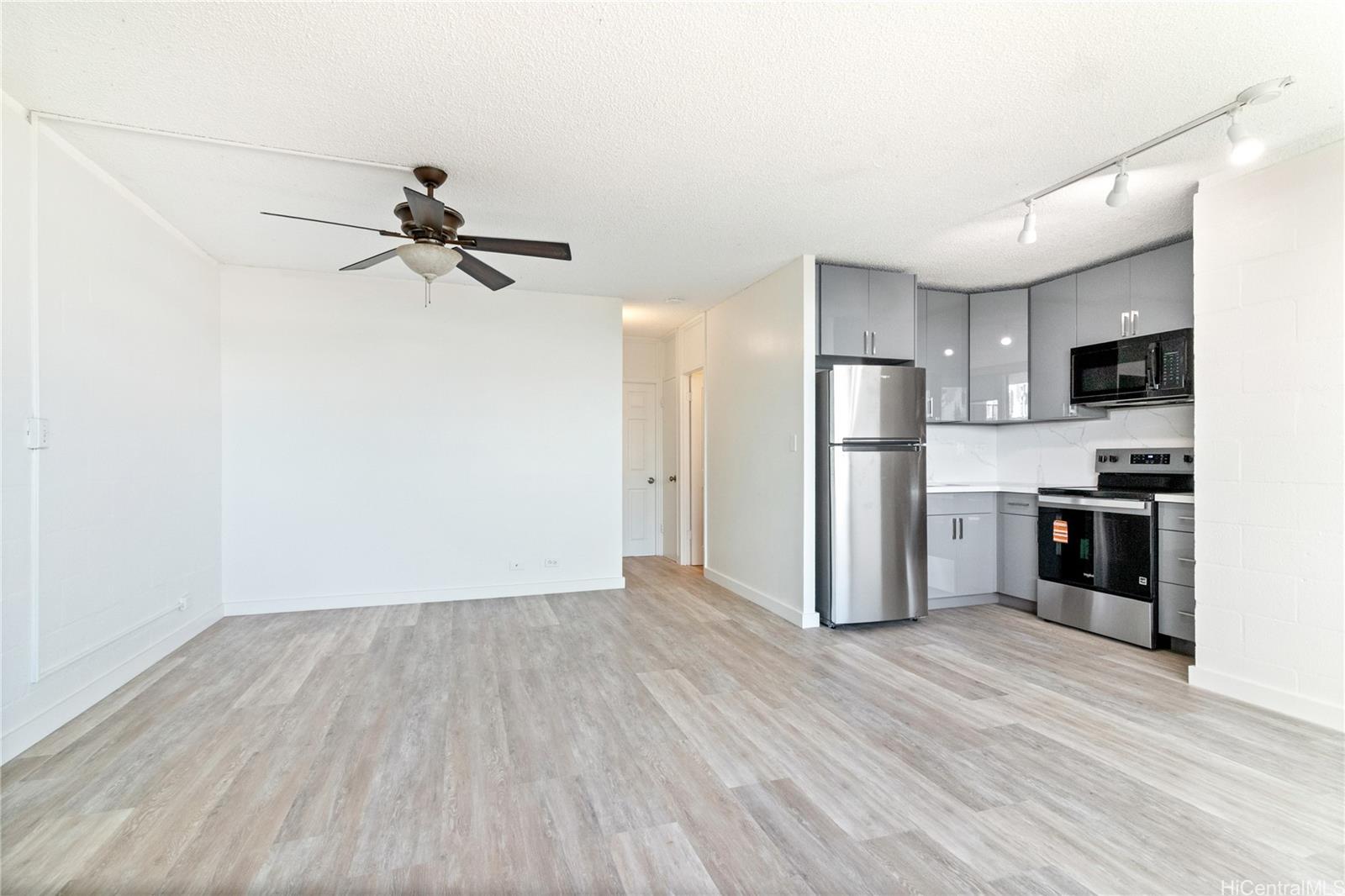94-249 Waikele Road, Unit A307 Waipahu, HI 96797 - Photo 5 of 20 a view of a kitchen with a sink and stainless steel appliances