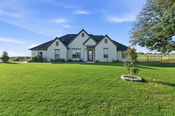 a front view of a house with a yard