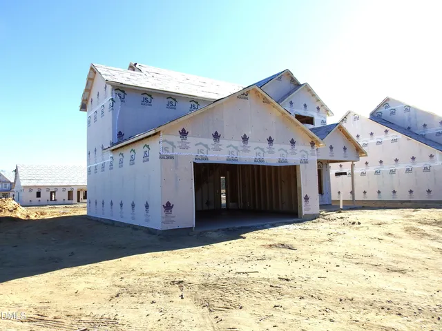 a view of a house with a wooden fence