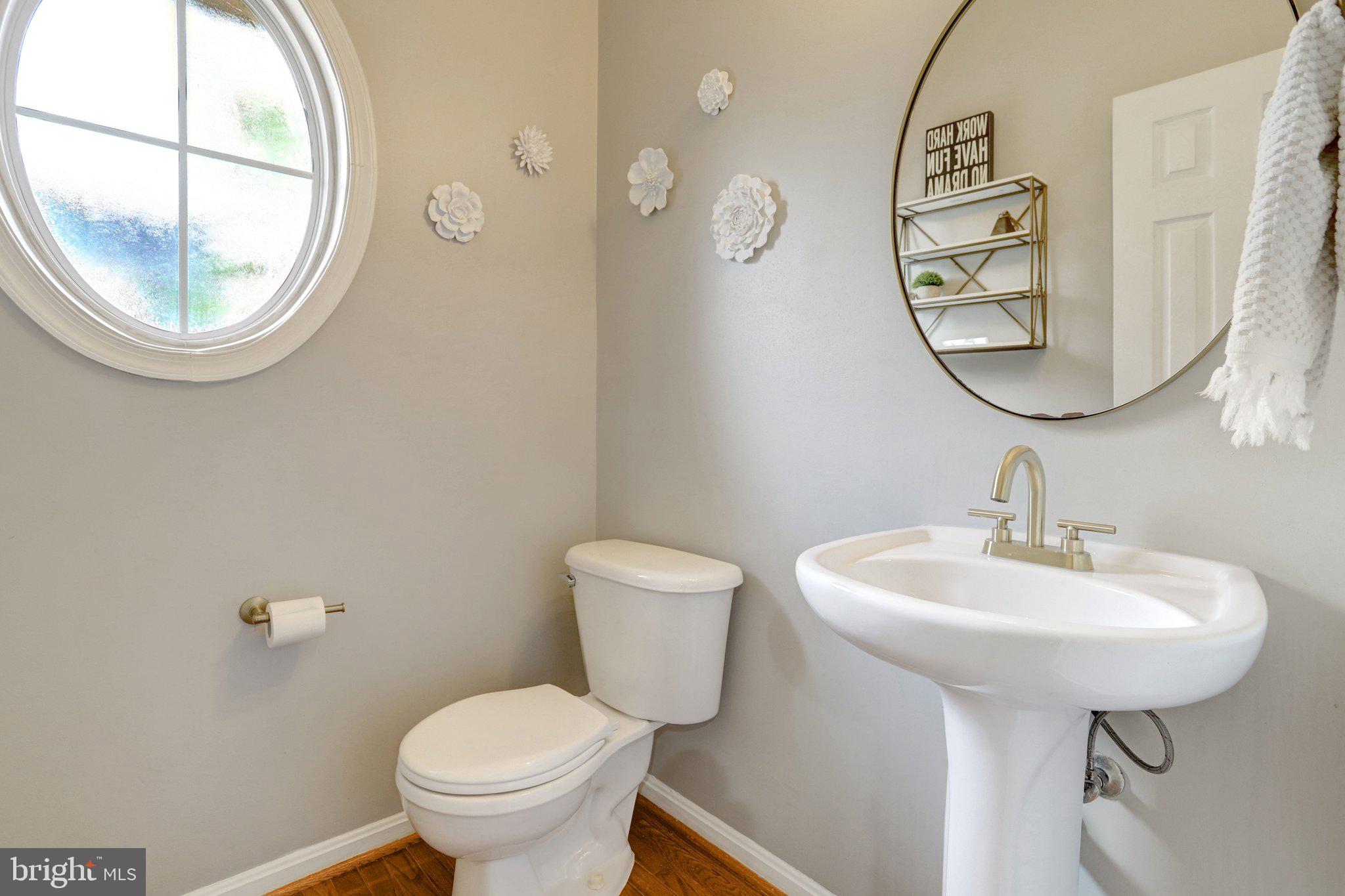 7374 Pohick Ridge Court Springfield, VA 22153 - Photo 16 of 58 a bathroom with a toilet a sink and a mirror