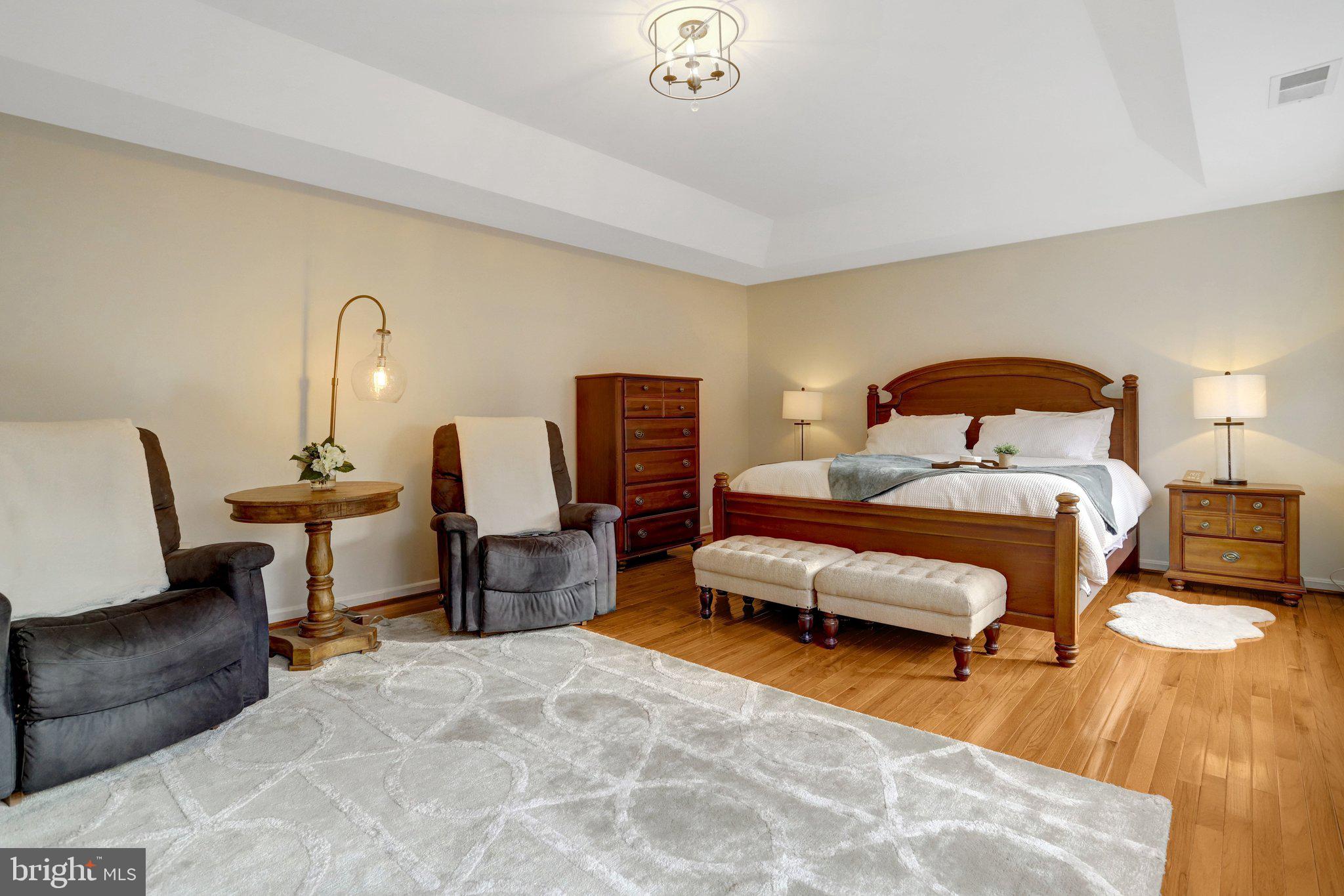 7374 Pohick Ridge Court Springfield, VA 22153 - Photo 17 of 58 a bedroom with furniture and a chair