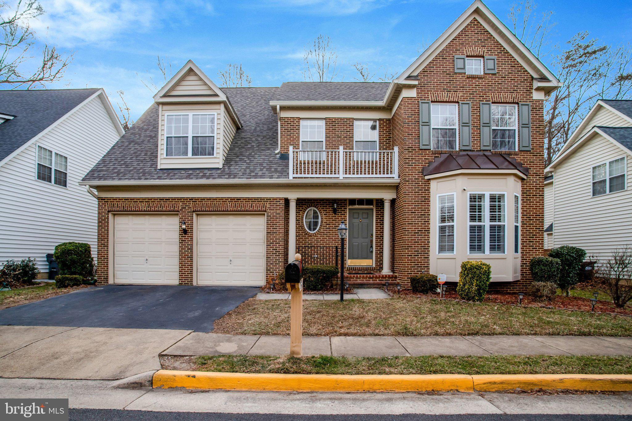 7374 Pohick Ridge Court Springfield, VA 22153 - Photo 2 of 58 a front view of a house with garden