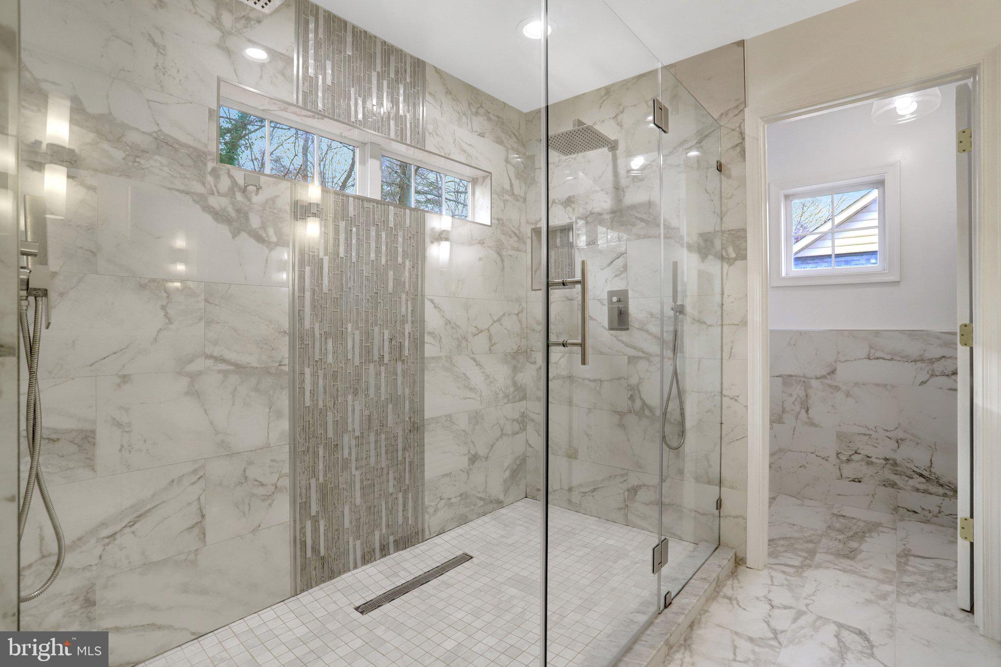 7374 Pohick Ridge Court Springfield, VA 22153 - Photo 22 of 58 a bathroom with a glass shower door and a shower